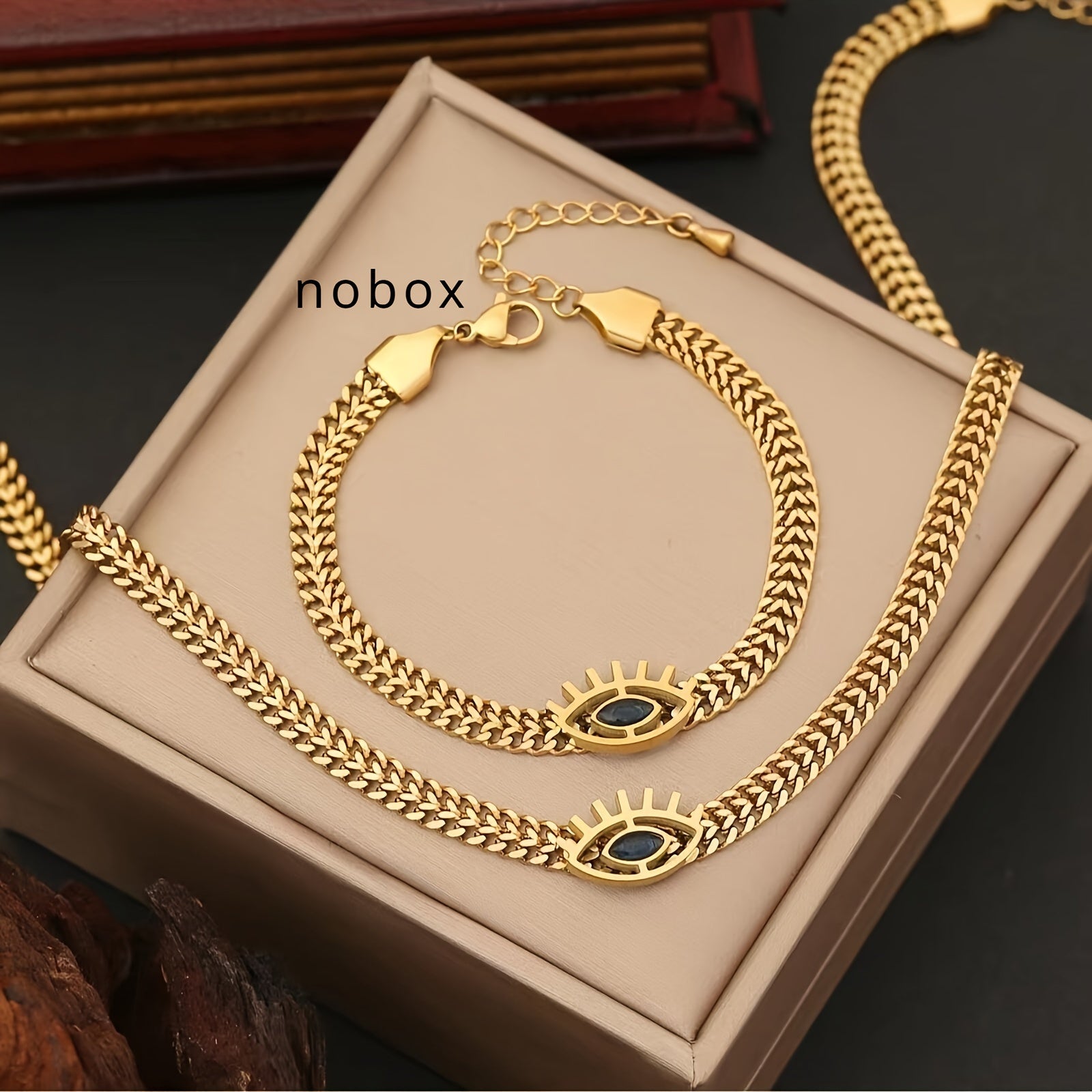 Set di collana e bracciale in acciaio inossidabile dorato con occhi vuoti, 2 pezzi, stile elegante e moderno.