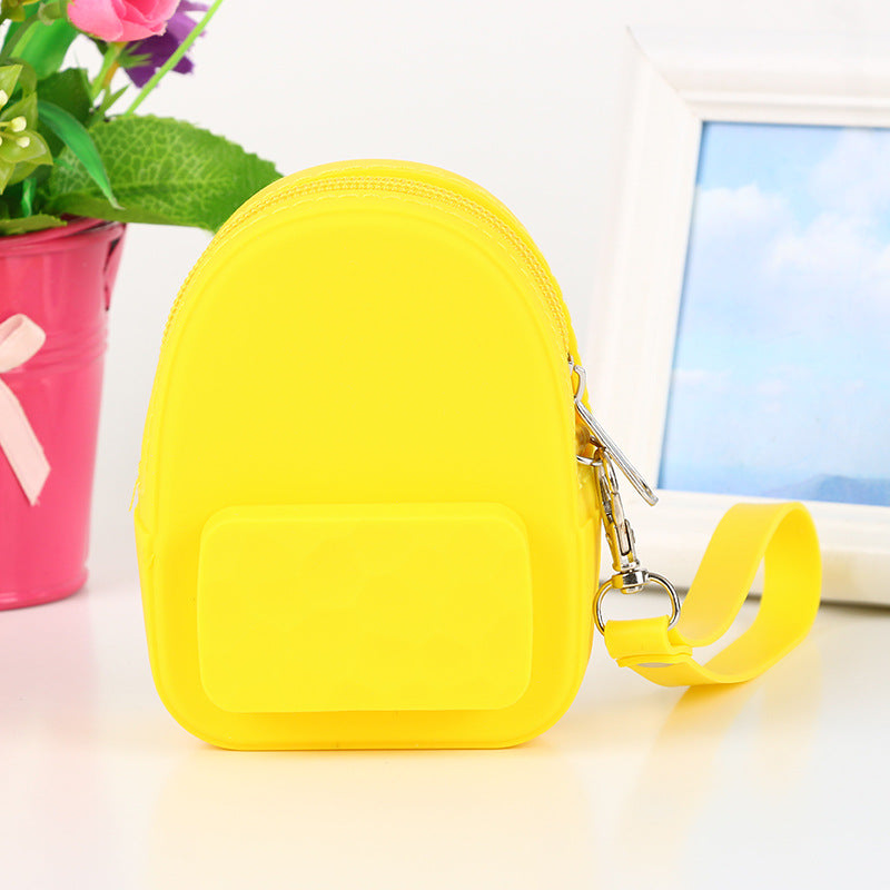 Borsa portachiavi in silicone colorata a forma di zaino portagioie per bambini, con design carino e pratico.