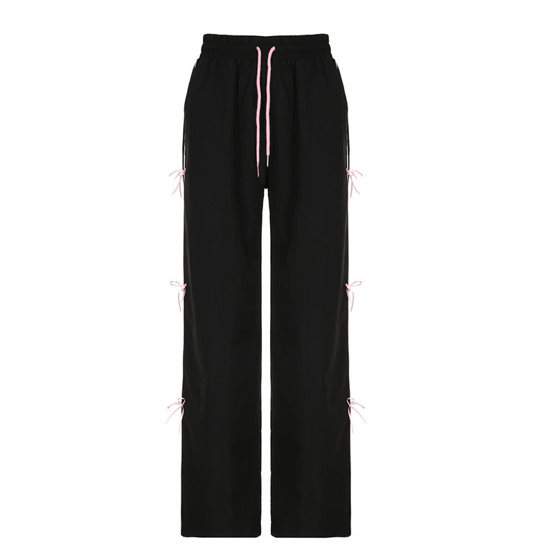 Pantaloni casual donna Valstrend con vita elastica a fiocco, dettagli in pizzo e motivo allacciato, comodi e eleganti.