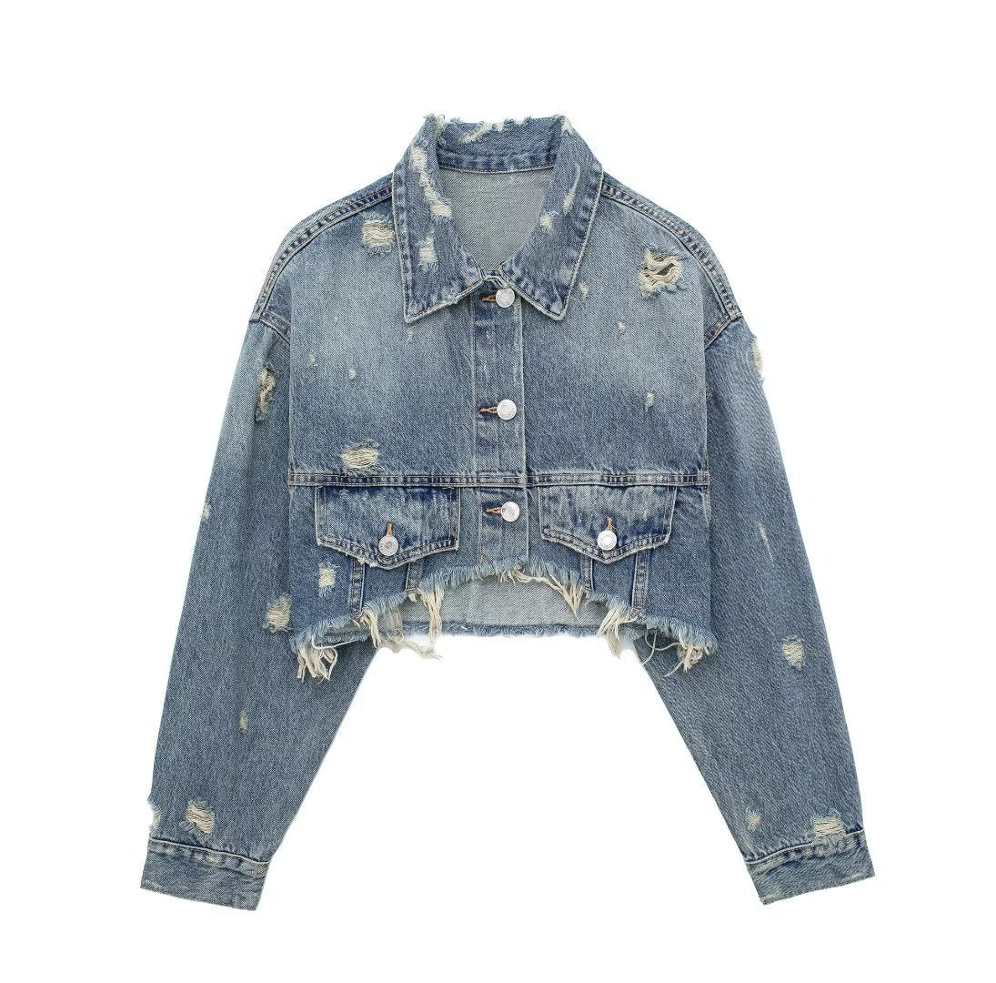 Giacca corta in denim con fori decorativi, stile perforato, marca Valstrend shop, visibile su modello con tasche e chiusura frontale