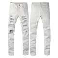 Jeans strappati bianchi con ricamo a fiore di anacardo Valstrend, dettagli di denim con strappi e decorazioni floreali.