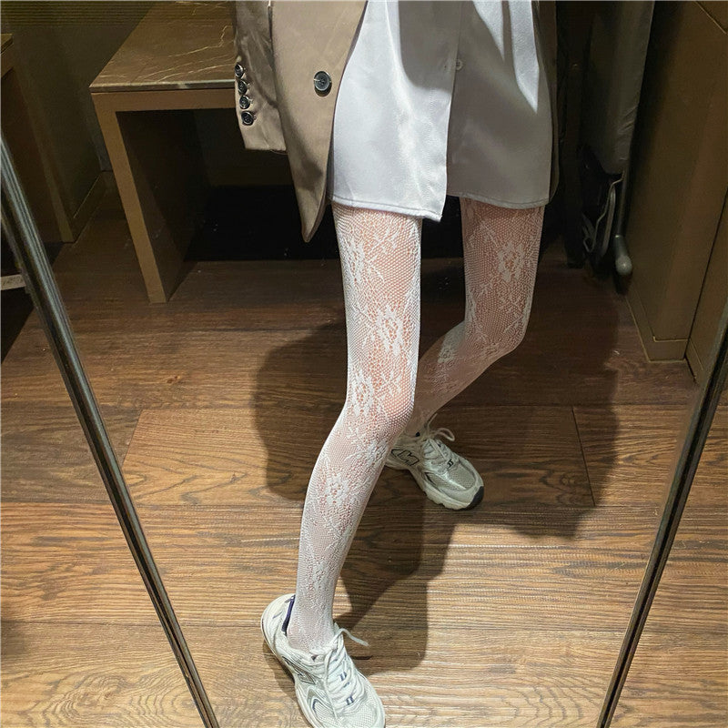 Calze da donna Valstrend con base in pizzo a rete sottile e motivo floreale, elegante e sexy, visibili in dettaglio nell'immagine.