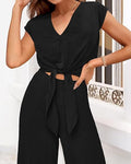 Completo donna Valstrend con top corto a V con cordoncino e pantaloni a zampa larga, stile moda femminile elegante e casual