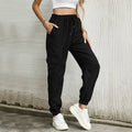 Pantaloni casual lunghi elasticizzati a vita bassa Valstrend in tessuto color solido, con fascia elastica alla caviglia