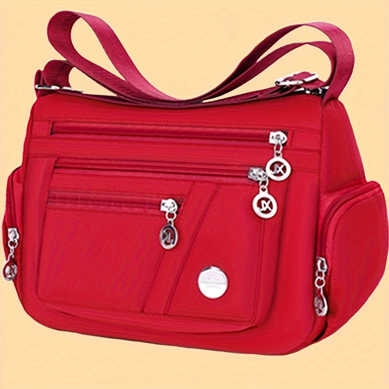 Borsa a tracolla in nylon casual con dettagli a nappina, con cerniera, tasche multiple e tracolla regolabile, ideale per uscite.
