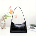 Borsa a spalla Valstrend con motivo rettile, dettagli glitter, in eco-pelle resistente, con chiusura zip sicura, stile elegante e pratico.