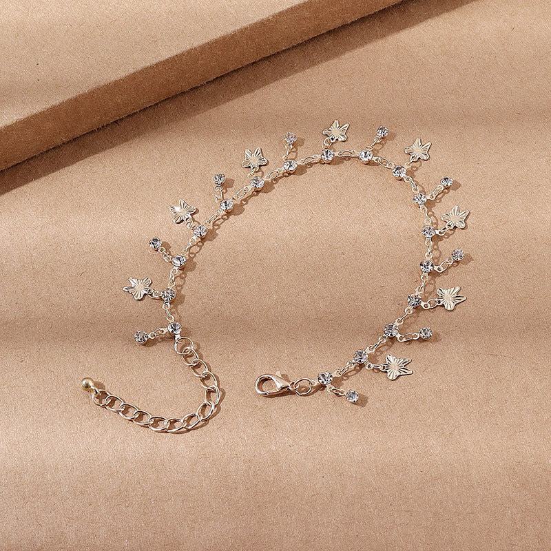 Bracciale alla caviglia con nappe farfalla colorate, fiori e foglie, gioiello Valstrend shop in stile boho e naturale.