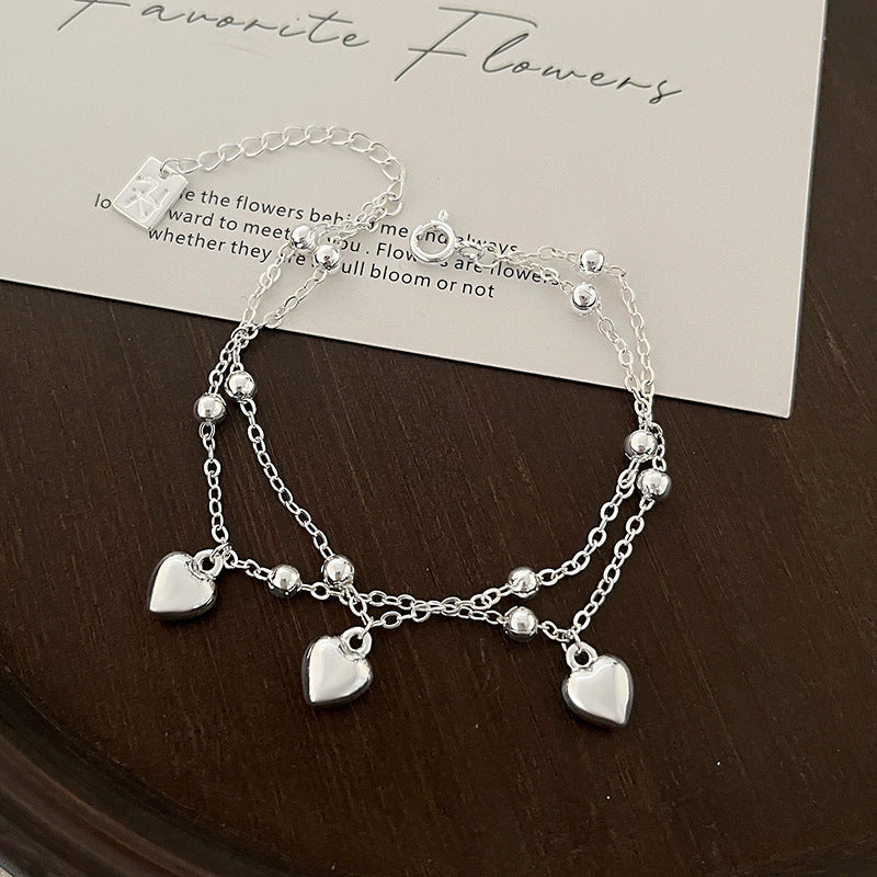 Bracciale Valstrend con cuore a forma di pesca a doppio strato e design tridimensionale, accessorio di interesse speciale.