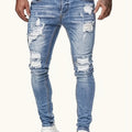 Jeans uomo skinny strappati in denim di Valstrend, vestibilità slim, cotone elasticizzato, lavaggio vintage, lunghezza regolare.